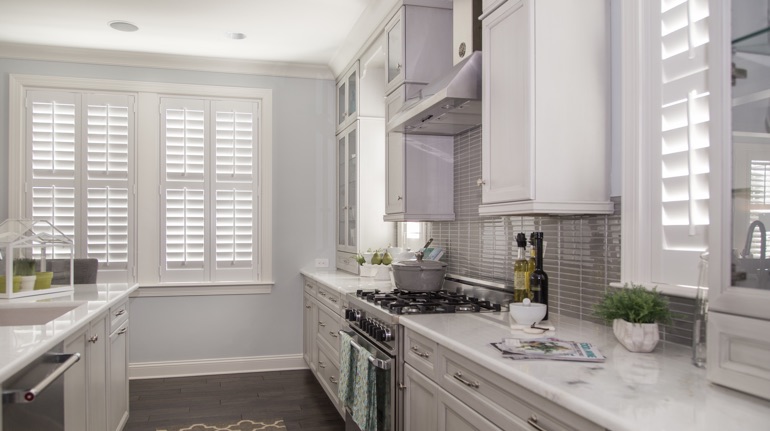 White shutters in New Brunswick kitchen with marble counter.